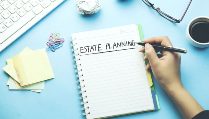 woman written estate planning text on paper in blue background