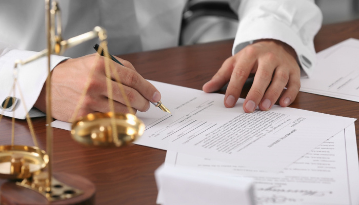 Notary public in office signing document about wills and trusts. Estate Planning