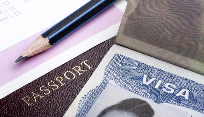 Passport,And,Us,Visa,Background,With,Immigration,Application,Form.
